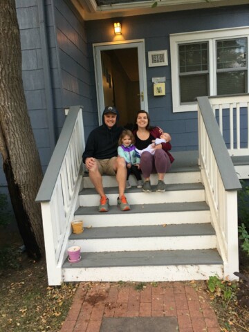 A family sitting on steps.