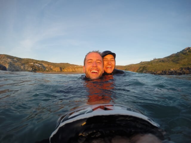 Two staff member smiling in the water.