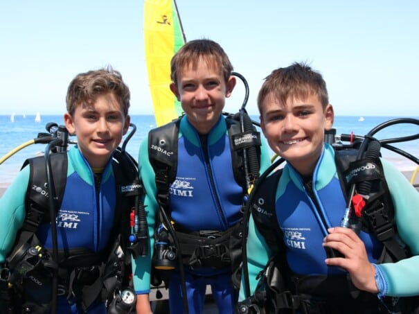 Three campers in scuba diving gear.