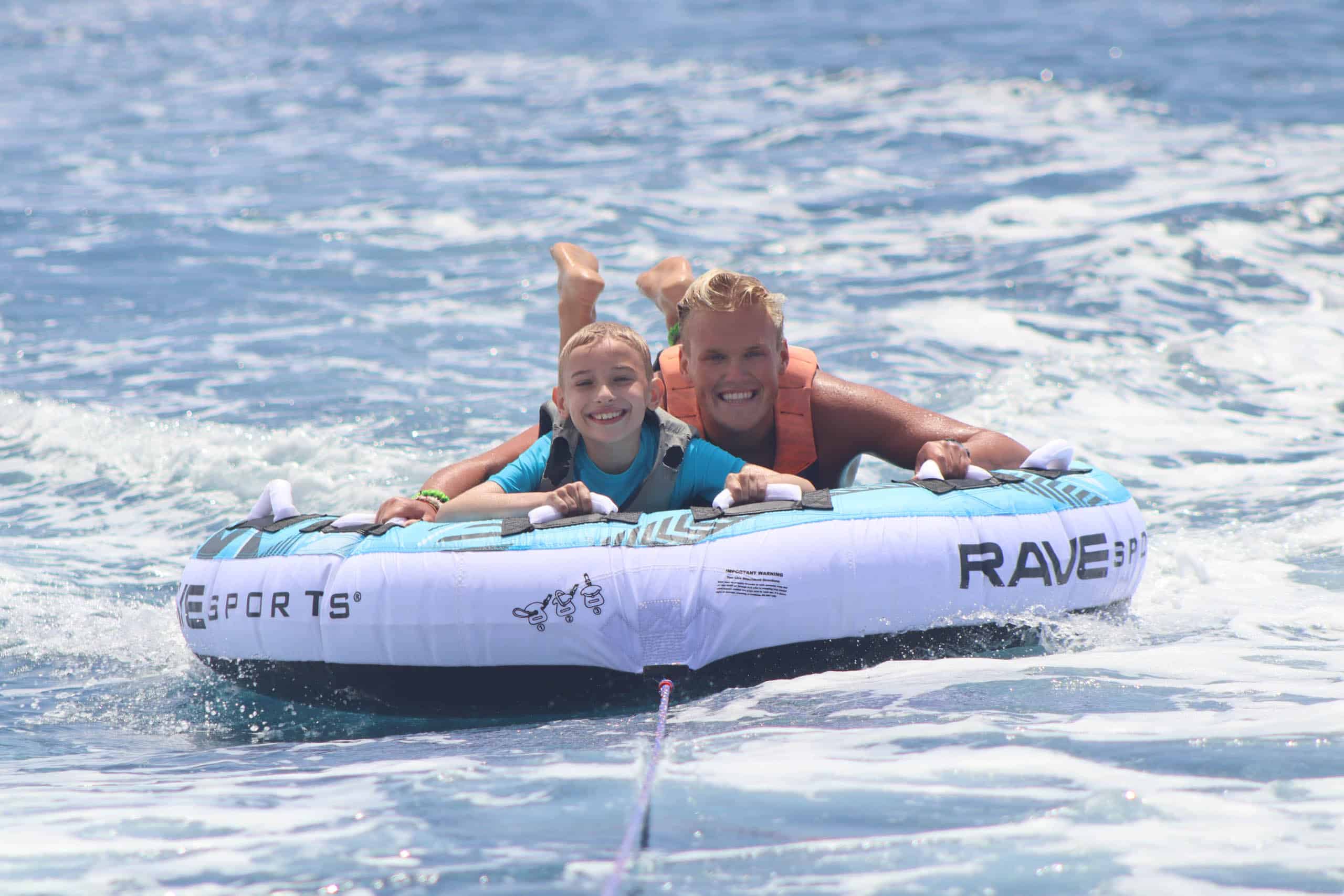 A CSC staff member and camper tubing.